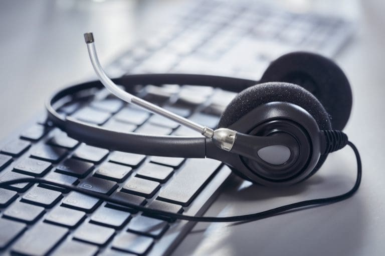 Empty headset at a computer desk